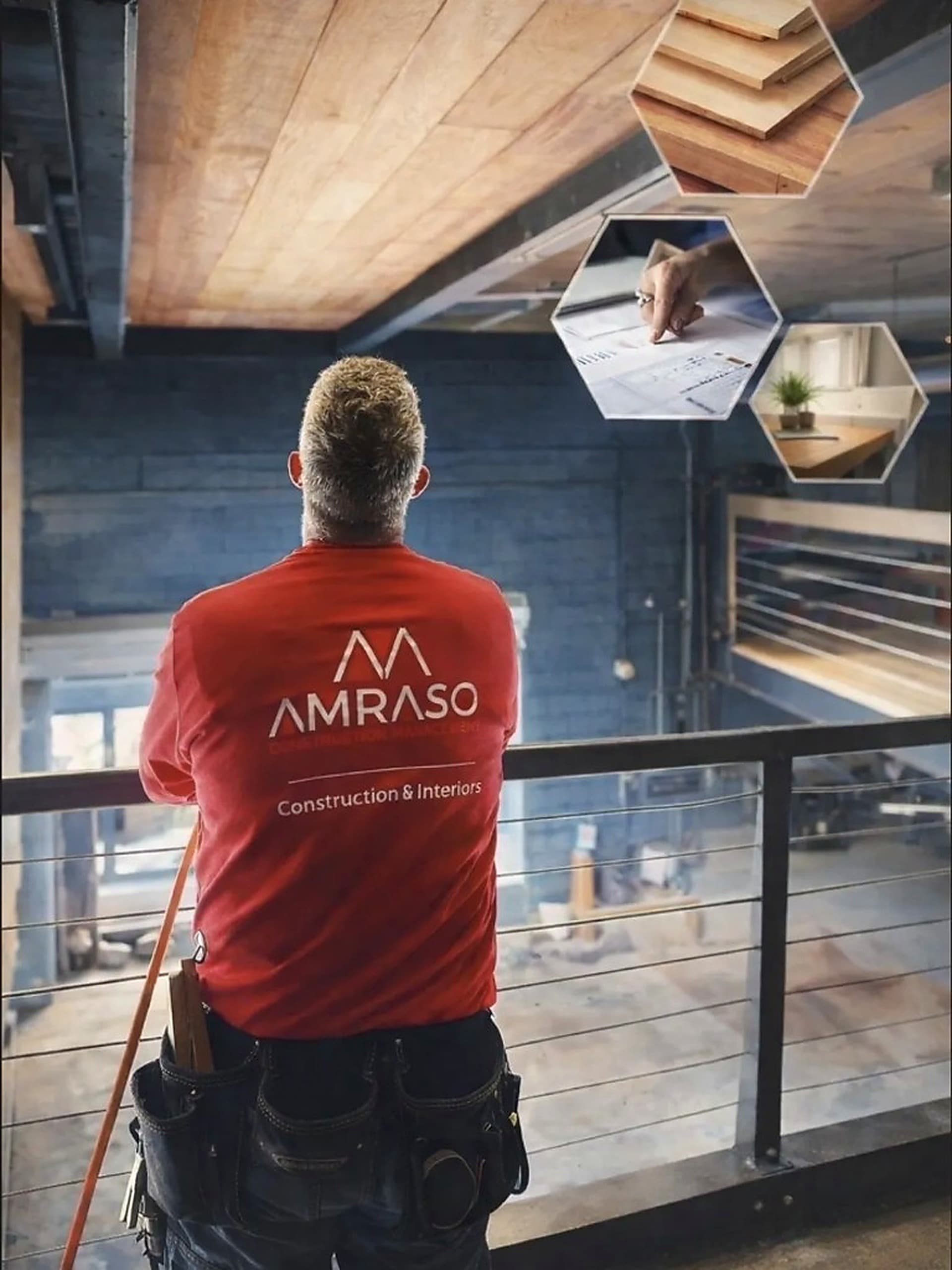 AMRASO construction manager in a branded red shirt overlooking an interior fit-out from a mezzanine railing